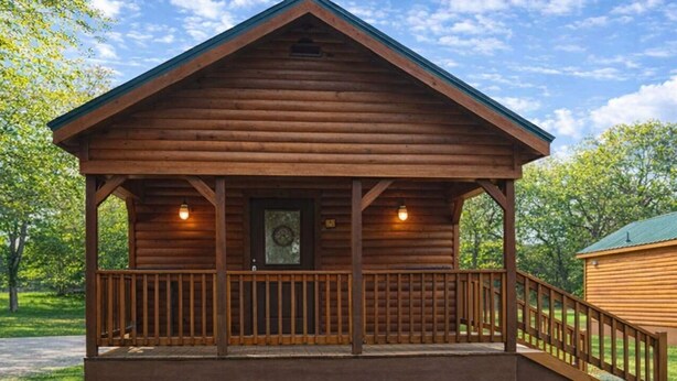 A wooden cabin with a porch, a small window, and a door. - Beautiful Log cabin overlooking a meadow (Pipe Creek)