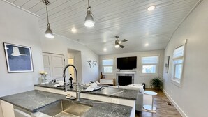 A modern kitchen with granite countertops, stainless steel appliances, and pendant lighting. - Beautiful Serene Carriage House Apartment (Spearfish)
