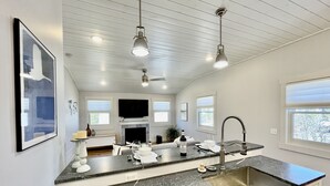 A modern kitchen with granite countertops, a built-in oven, and a large window. - Beautiful Serene Carriage House Apartment (Spearfish)