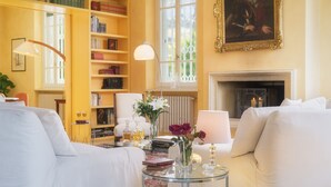 A cozy living room with a fireplace, a bookshelf, and a comfortable seating area. - Villa Gaius 8+2, Emma Villas (Rosignano Marittimo)