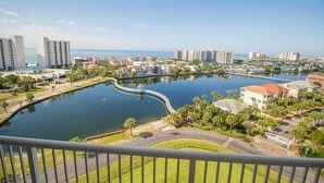 A residential area with a lake, buildings, and a clear sky. - Terrace at Pelican Beach 1005 2 Bedroom Condo by Pelican Beach Management (Destin)