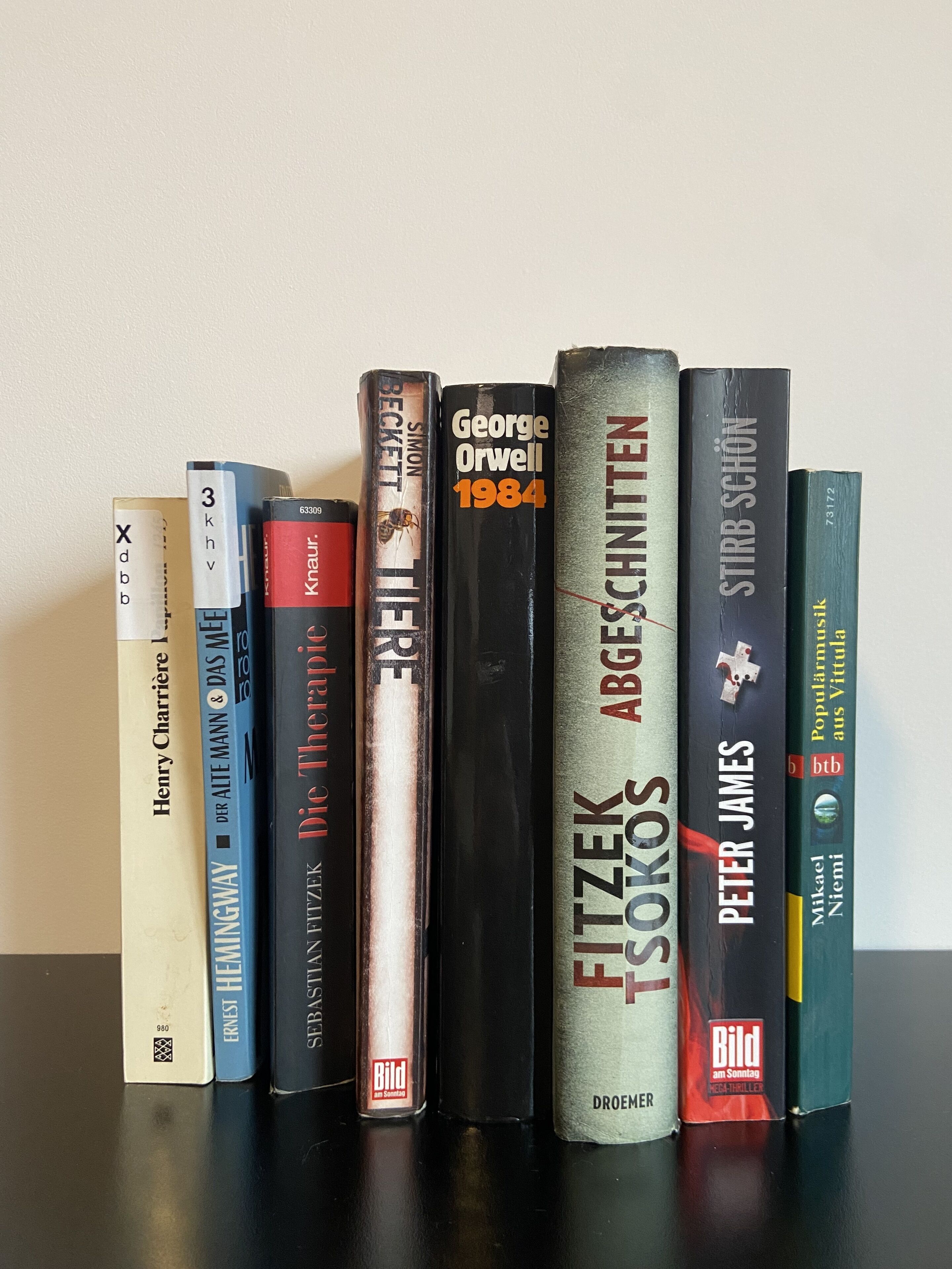 A collection of books on a shelf.