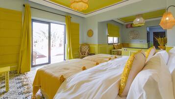 Una habitación de hotel con una cama grande, un pequeño espacio de cocina y vistas al exterior.
