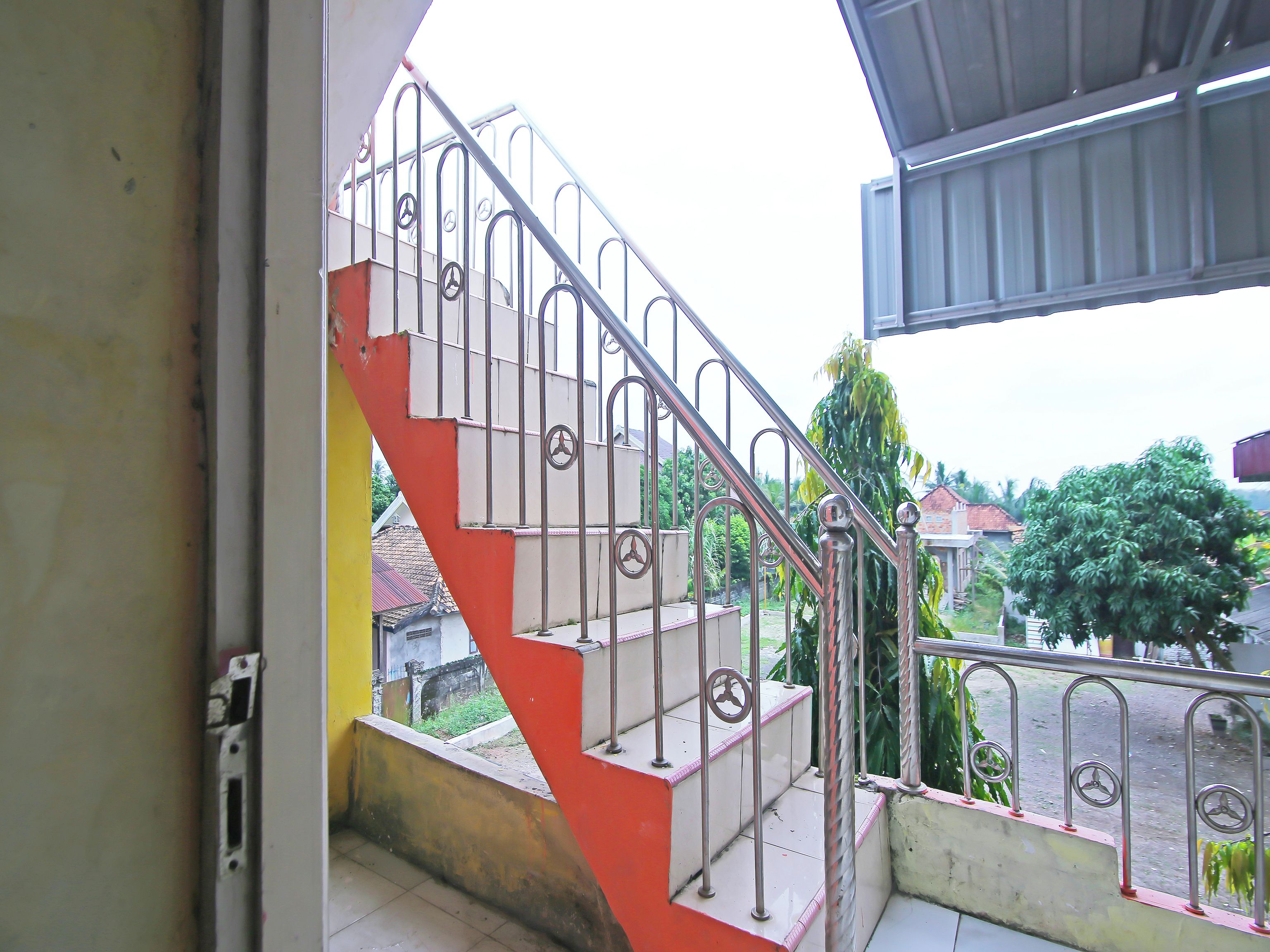 A staircase with metal railings and a red and white color scheme.