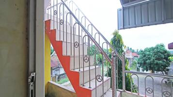 A staircase with metal railings and a red and white color scheme.
