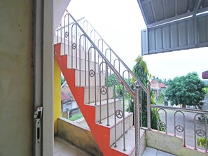 A staircase with metal railings and a red and white color scheme.
