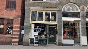 A two-story building with a cafe on the ground floor. - Lower East side NYC in Old Bisbee (Bisbee)