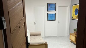 A bedroom with a bed, a wardrobe, and a ceiling fan. There are two doors and a small cabinet. - Ap Copacabana 200m da praia - CP2 (Rio de Janeiro)