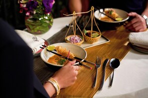 A dining table with a plate of food, chopsticks, and a bowl of soup. - The Westin Resort & Spa, Himalayas (Narendranagar)