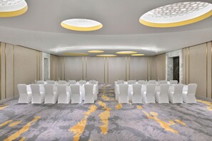 A conference room with rows of white chairs, a patterned carpet, and a modern ceiling design. - The Westin Resort & Spa, Himalayas (Narendranagar)