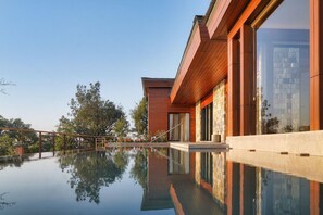 A modern building with a reflective pool in front. - The Westin Resort & Spa, Himalayas (Narendranagar)