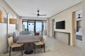 A modern living room with a dining area, a ceiling fan, a flat-screen TV, and a view of the outdoors. - The Westin Resort & Spa, Himalayas (Narendranagar)