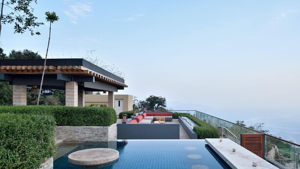 A modern outdoor pool area with a seating area and a view of the landscape. - The Westin Resort & Spa, Himalayas (Narendranagar)