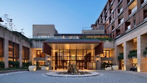 A modern hotel with a central courtyard, large windows, and a water feature. - The Westin Resort & Spa, Himalayas (Narendranagar)