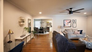 Un salon moderne comprenant un canapé, une table basse et un coin repas avec une table et des chaises.