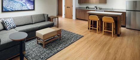 A modern apartment with a living room, kitchen, and dining area.