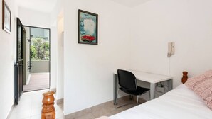 A bedroom with a bed, a desk with a chair, a window, and a door leading to a balcony. - Room in Guest Room - Cuarto En Las Lomas! (Naucalpan)