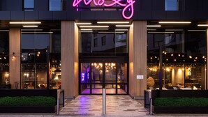 A modern building with a neon sign reading "moxy" above the entrance. - Moxy Halifax Downtown (Halifax)