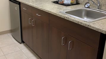 A kitchen with a microwave, sink, and dishwasher.