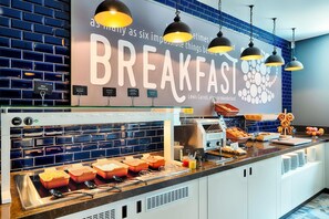 A breakfast buffet with labeled containers, a coffee machine, and a sign reading 'Breakfast Wonderland'. - Premier Inn Darmstadt City Centre (Darmstadt)