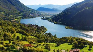 A mountainous landscape with a lake and scattered houses. - Inviting 1-bed Apartment With Box and Seeviews (Ranzanico)