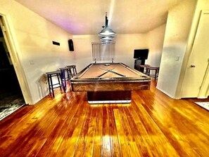 Enjoy a game of pool in this cozy room with a pool table and comfortable seating for four.