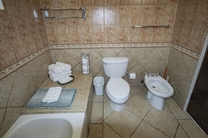 A bathroom with a bathtub, toilet, bidet, and a towel rack. - Costa Bonita Private Villa 604 (Culebra)