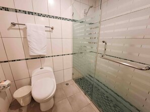 A bathroom with a toilet, a glass shower enclosure, and a towel rack. - 3 Bedrooms At Marbella Beachfront Juan Dolio No820 (Guayacanes)