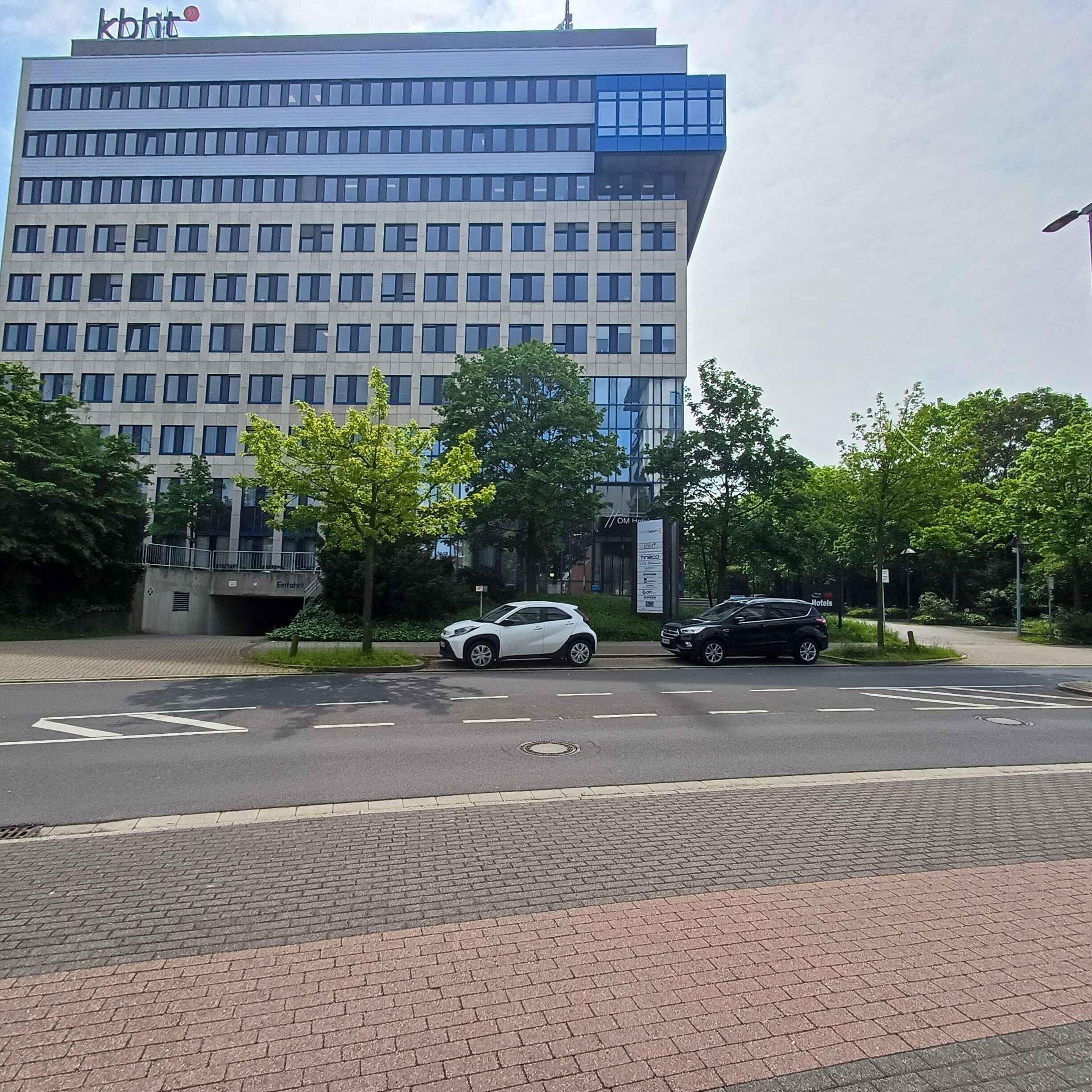Un edificio moderno con una sezione superiore blu e numerose finestre.