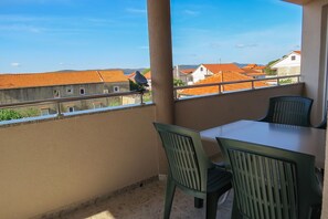Enjoy dining or relaxing on the balcony with a view of the surrounding neighborhood.