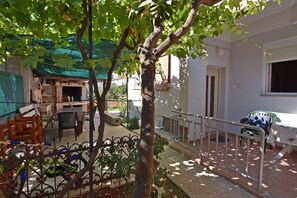 A courtyard with a pergola, outdoor seating, and a small garden area.