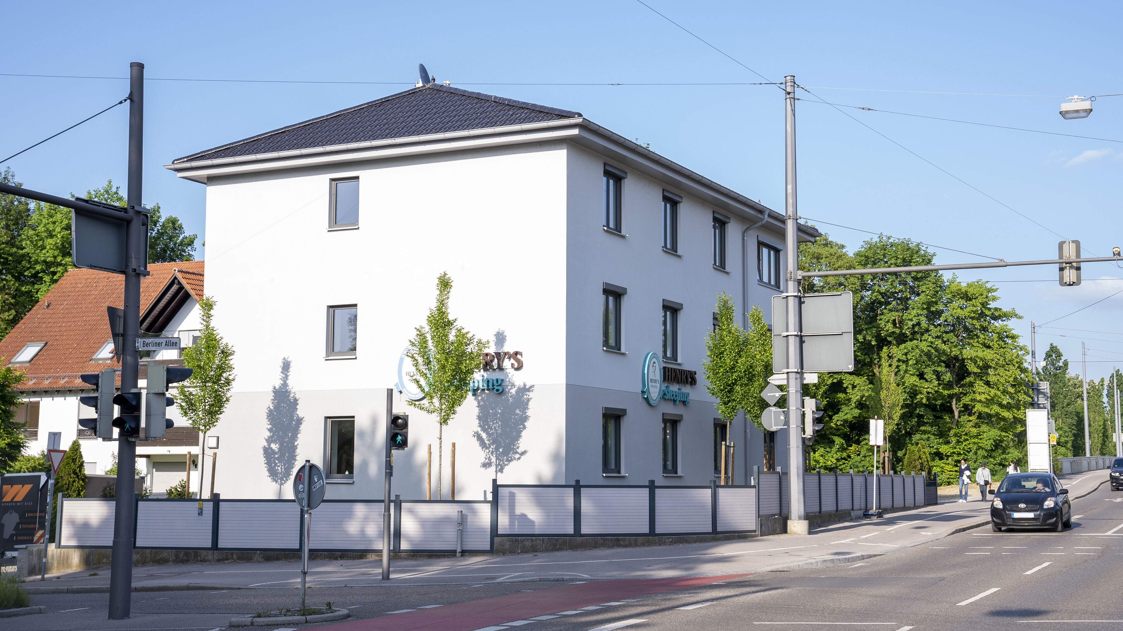 A white building with multiple windows and a sign that reads "RY'S".