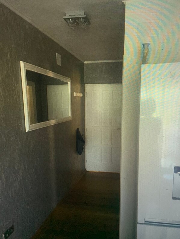 A hallway with a mirror, a coat rack, and a door. - Apartments Vranela- One Bedroom Apartment With Balcony (Biograd na Moru)