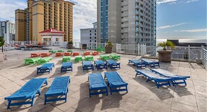 Relax and socialize on the rooftop terrace with ocean views, lounge chairs, and tables.