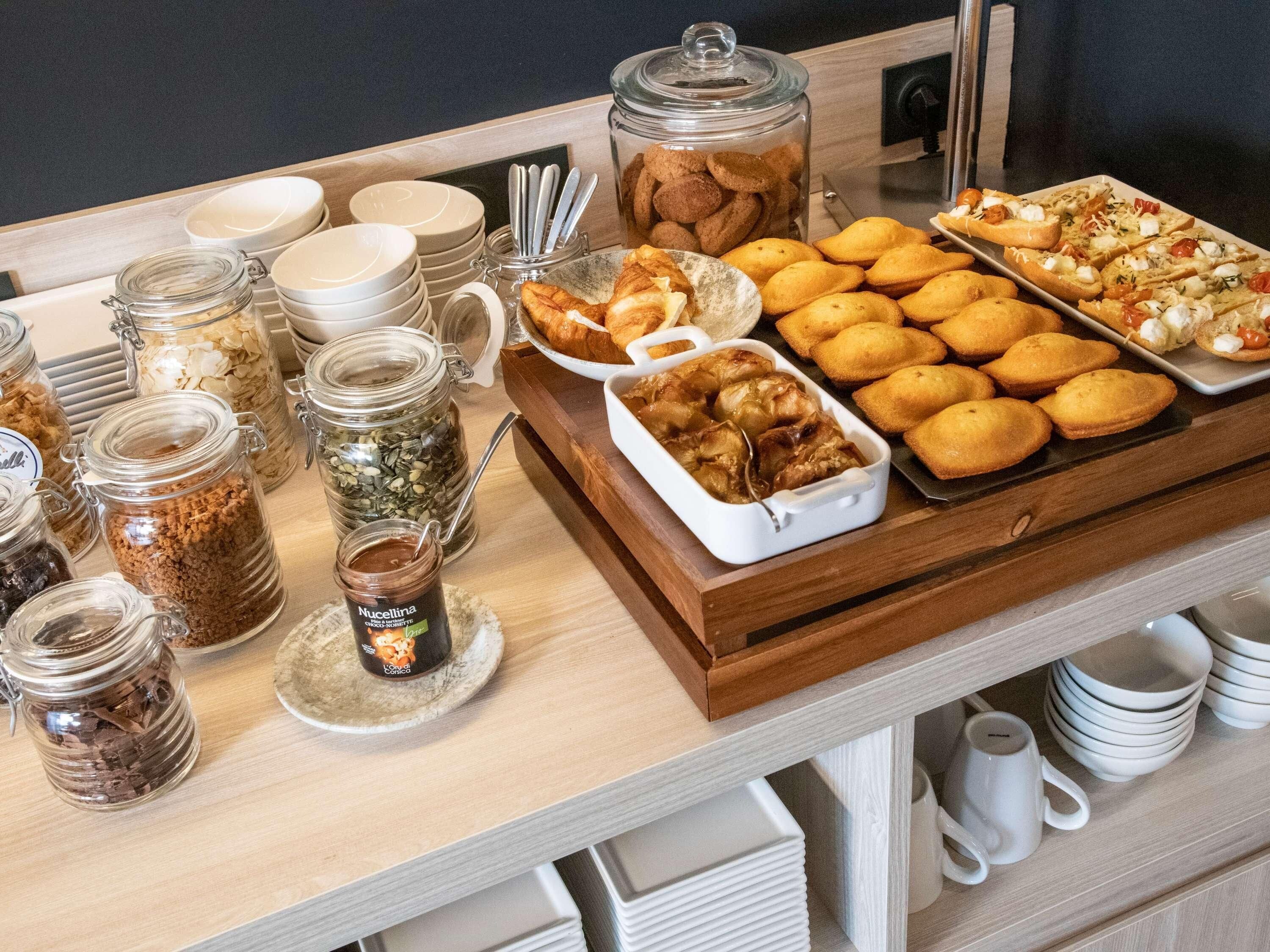 A breakfast buffet with various food items and condiments.