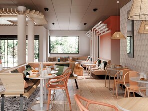 A modern cafe with round tables, orange chairs, and a large window offering a view of greenery. - Ibis Styles Porto Vecchio (Porto-Vecchio)
