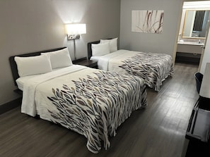 A hotel room with two beds, a nightstand, a lamp, a mirror, and a painting on the wall. - Red Roof Inn Birmingham – Highway 280 (Birmingham)