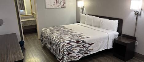 Premium bedding, desk, laptop workspace, blackout drapes