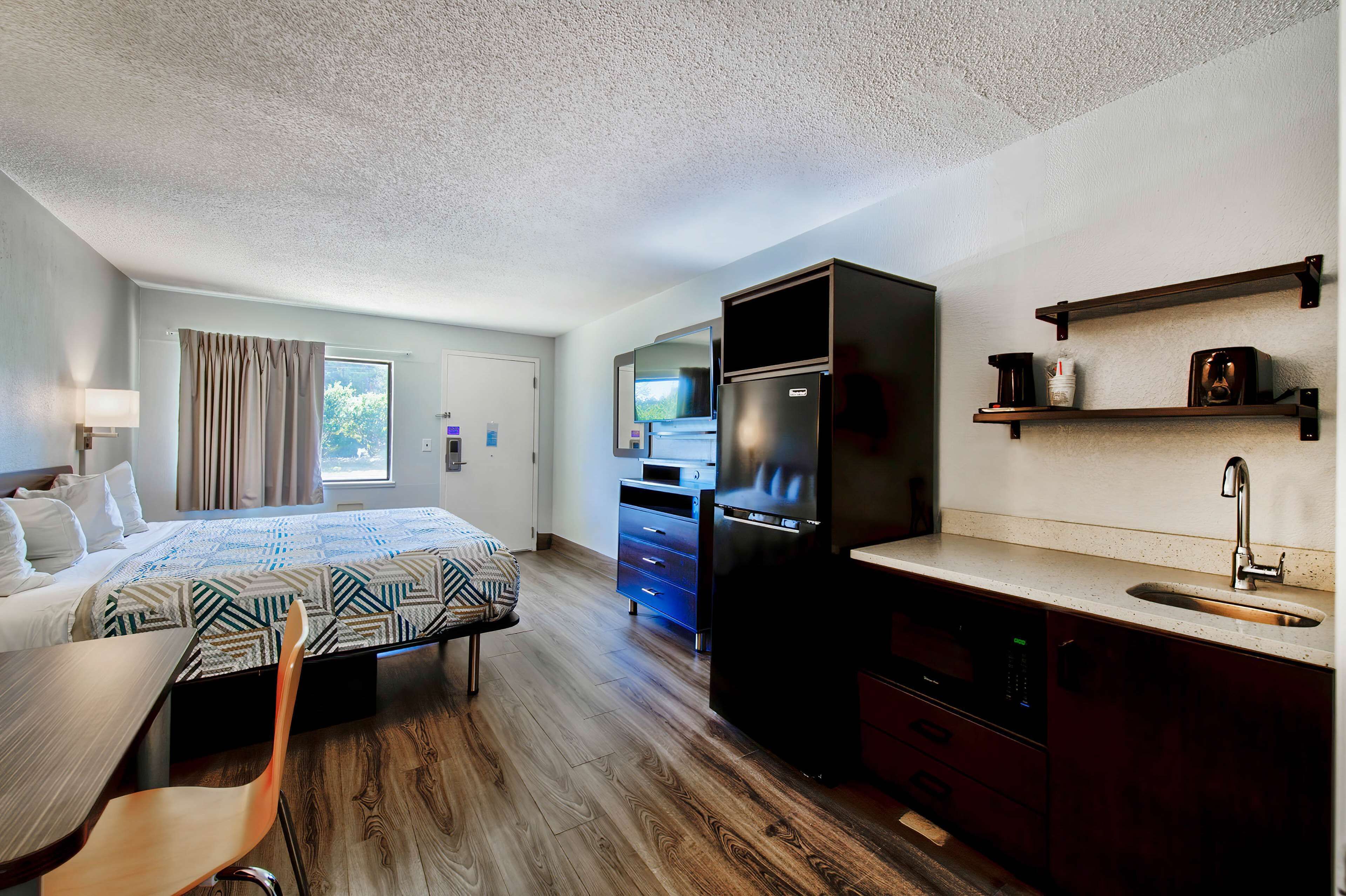 Premium bedding, desk, laptop workspace, iron/ironing board