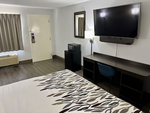A hotel room with a bed, a TV, a desk, a chair, a desk lamp, and a window with curtains. - Red Roof Inn Birmingham – Highway 280 (Birmingham)