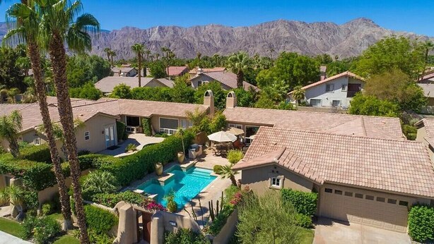 A residential area with houses, a swimming pool, and mountains in the background. - Rancho La Quinta community with amazing pool (La Quinta)