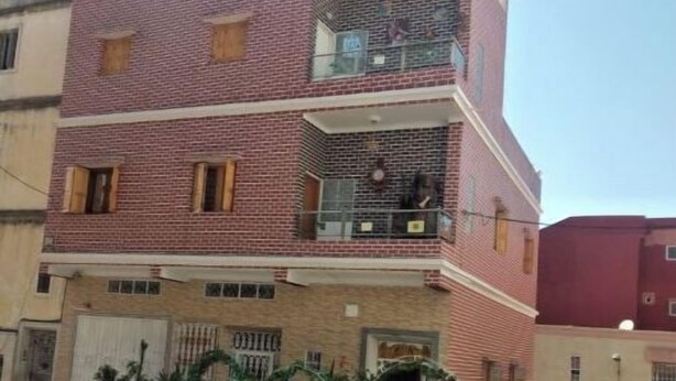 A two-story building with a balcony on the second floor. - House in Tangier (Tanger)