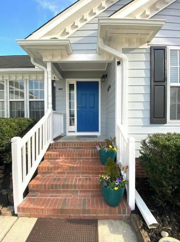 Traditional home with a charming front porch and symmetrical design.