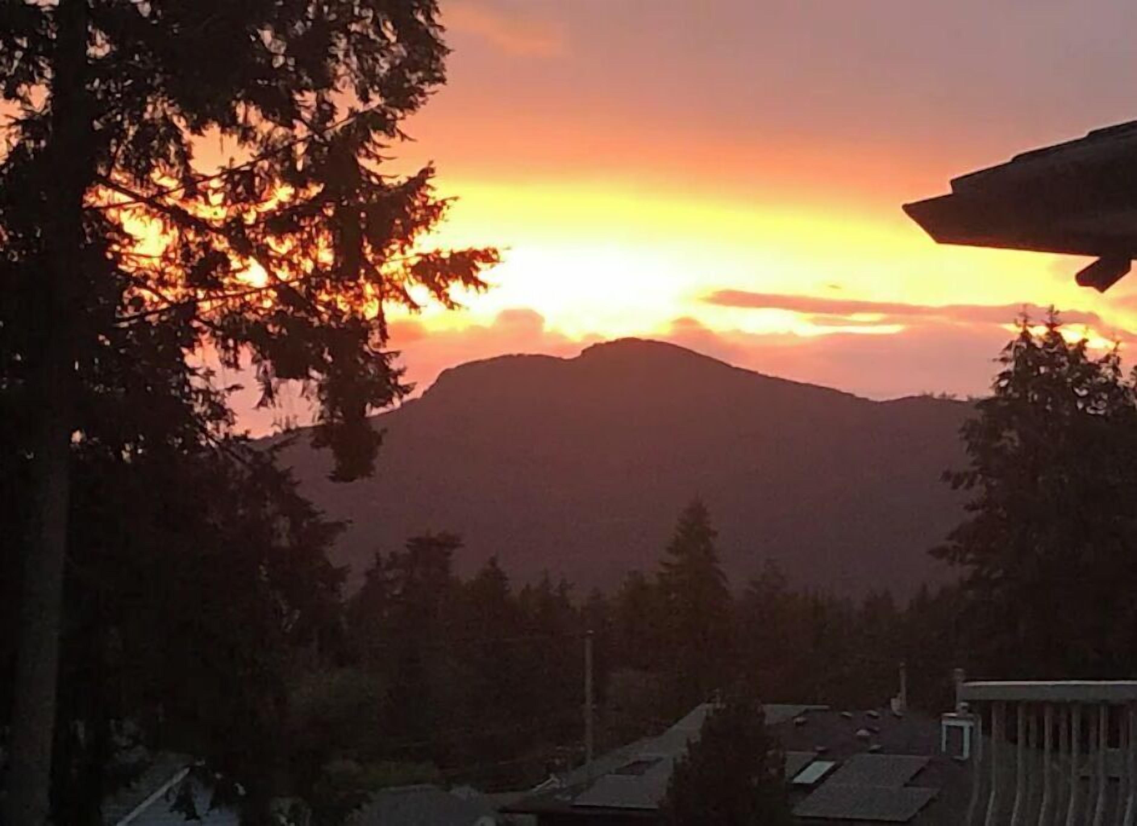 A mountain landscape with a sunset.