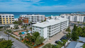 A hotel with multiple floors, a swimming pool, and a view of the ocean. - Welcome to your happy place—aka where real life takes a vacation. (Sarasota)