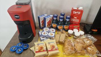 A variety of food items and a coffee machine on a table.
