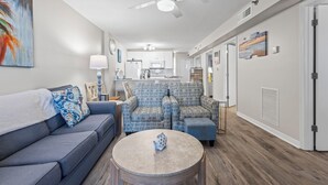 Un salon moderne avec un canapé, des fauteuils et une table basse.
