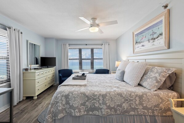 A bedroom with a bed, a TV, a dresser, and a ceiling fan. - Incredible Ocean Front Views, Indoor/Outdoor Pool, Hot Tub, Fully Stocked, 4 TVs (Orange Beach)