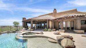 A house with a swimming pool, patio, and large rocks. - Sonoran Desert Retreat - Quiet, Gated, Custom home with Incredible SUNSETS ! (Scottsdale)