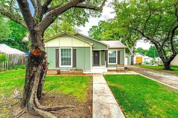 A single-story house with a front porch, a visible mailbox, and a well-maintained lawn.